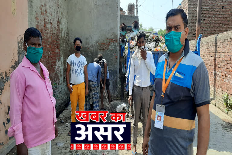 Garbage is being lifted from the front of Idgah