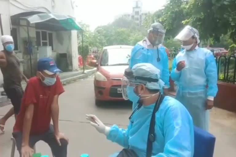 Doctors treating patients outside the building at Rohini ESI Hospital