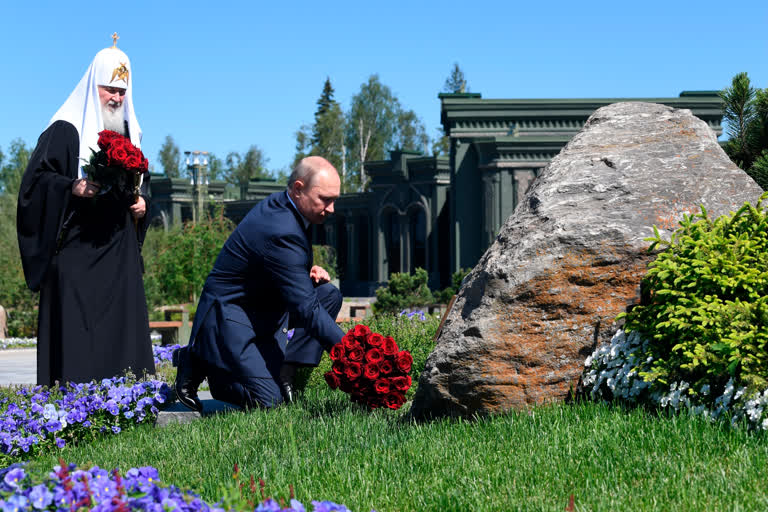 Russian President Vladimir Putin (right) and Russian Orthodox Church Patriarch Kirill lay flowers to a monument to Mothers of the Victors after a religion service marking the 79th anniversary of the Nazi invasion of the Soviet Union, at the Cathedral in the Patriot Park outside Moscow, on Monday.