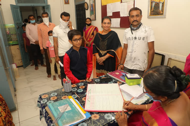 Parents lined up to get admission in a government school in Ghoghavdar village of Gondal