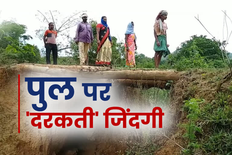 Villagers pass through a shabby bridge of malam panchayat in Gumla