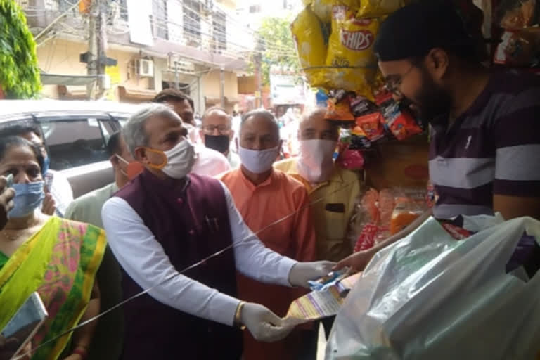 delhi bjp president adesh gupta distribute sanitizer and decoction packets