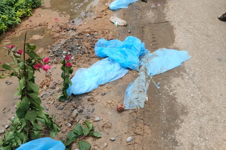 PPE kits lying across the road.