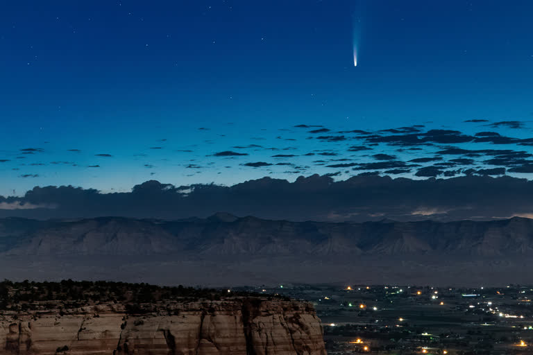 Comet Neowise soars in the horizon of the early morning sky in this view from the near the grand view lookout at the Colorado National Monument west of Grand Junction, Colo., on Thursday.