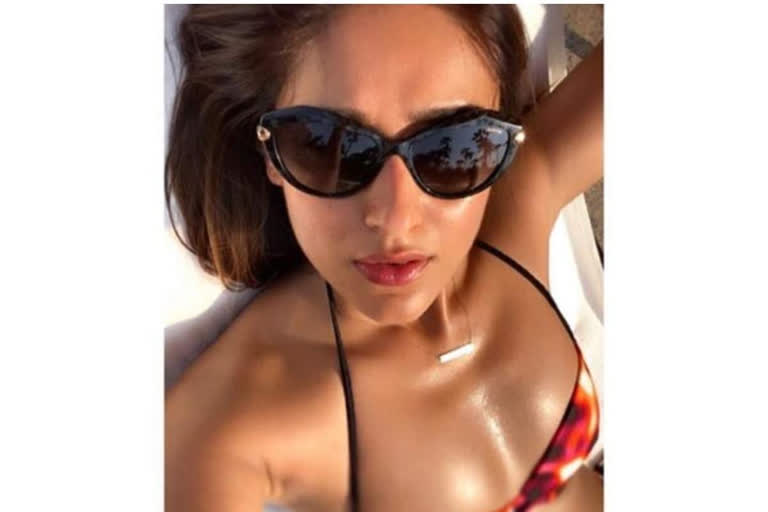 Ileana D'Cruz sharing a throwback sun-kissed post of herself soaking in the sun by the pool