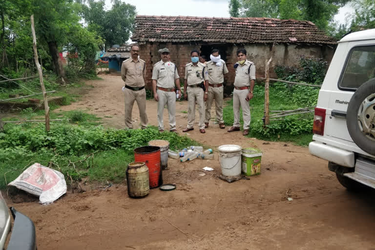 police with seized raw liquor