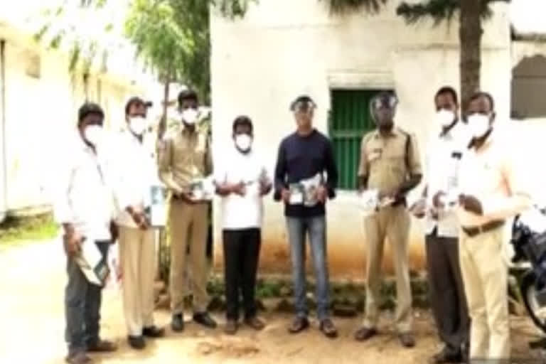 ex-zptc distributed masks and face shields to police at dubbaka in siddipet district