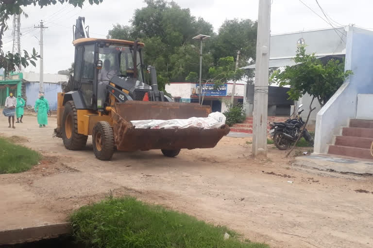 Burial of young man's body with JCB