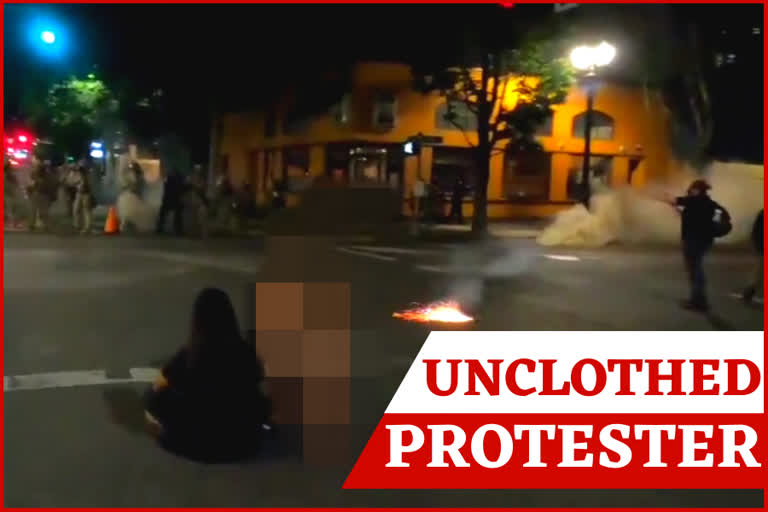 Nude Portland protester up against officers