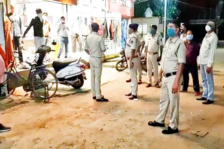 Police giving instructions to shopkeepers