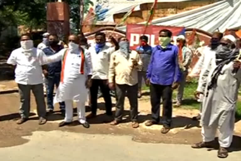 protest at adilabad collector office against bjp