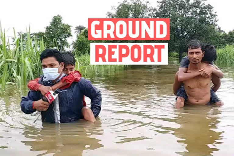 ETV Bharat reporter carries child to safety through floodwaters in Bihar