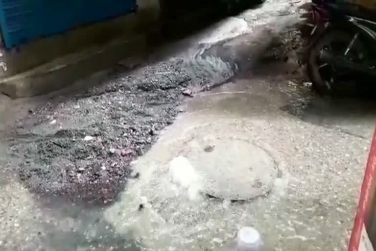 Overflowing sewer in streets after rain in Munirka