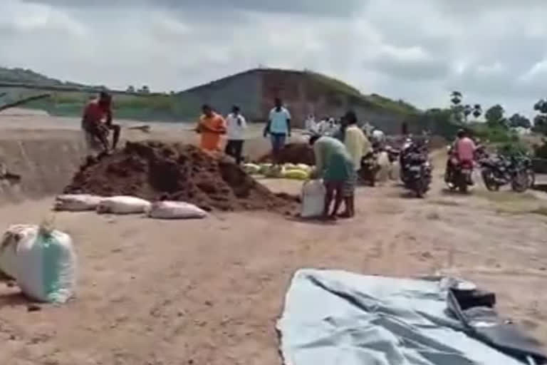 Local village farmers repairing works to the Potharam pond in jagtial district