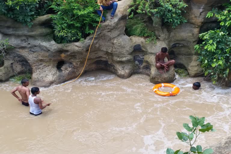 Youth immersed in river