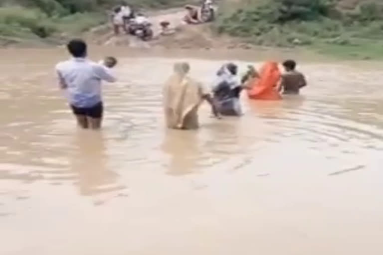 Villagers crossing the river