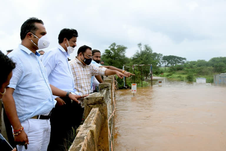 Jarakiholi reviewing the flood situation with the Maharashtra minister