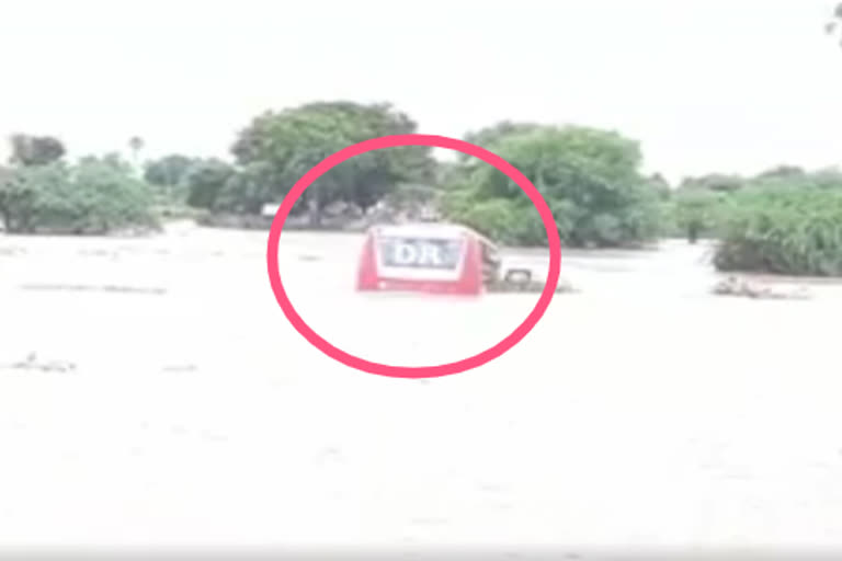 a private bus stuck in water in damera mandal warangal rural district