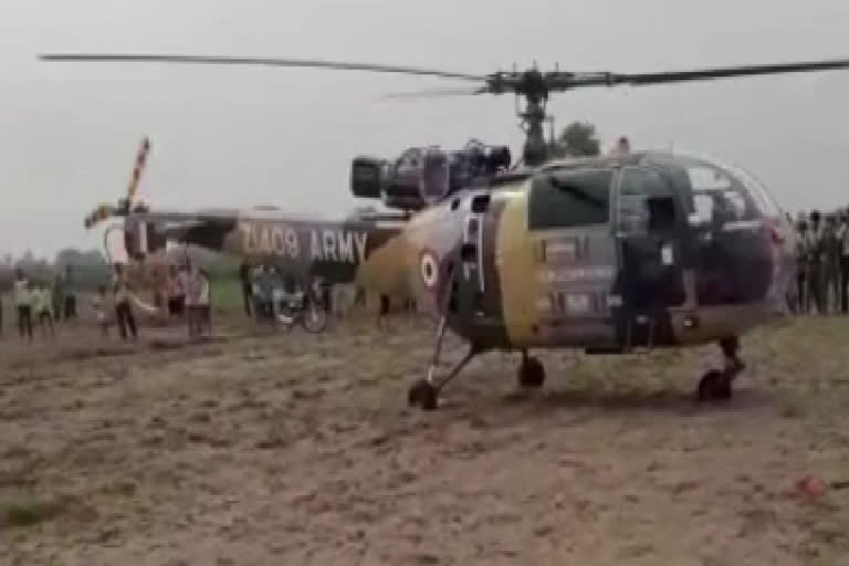 Emergency landing of helicopter,  helicopter landed in field