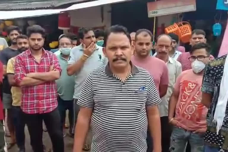 Shopkeepers protest MLA Arjun Singh's decision to stop the tiles work