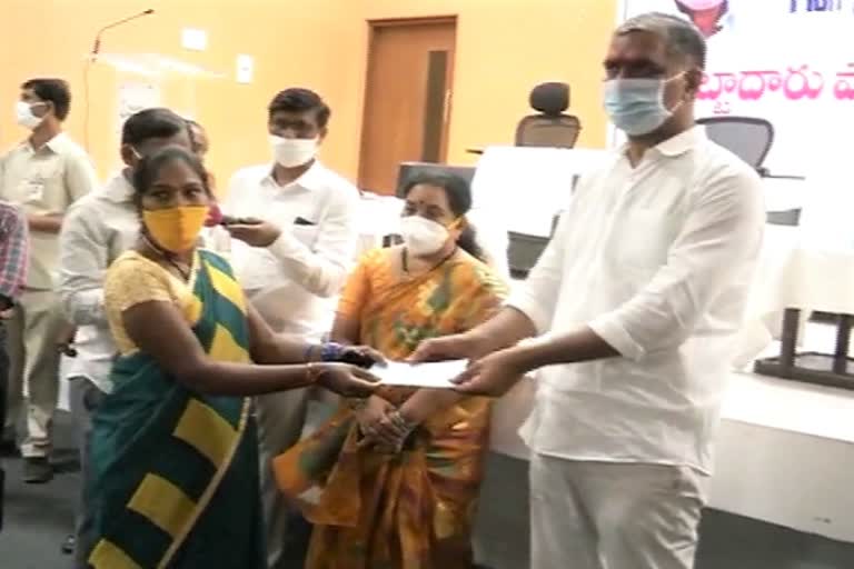 minister harish rao distribute land pass books