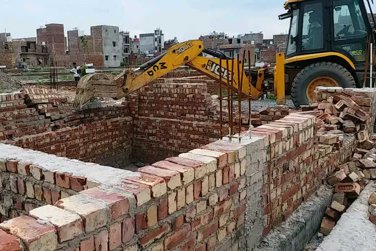 demolition action taken at illegally developing anguri devi society at burari in delhi