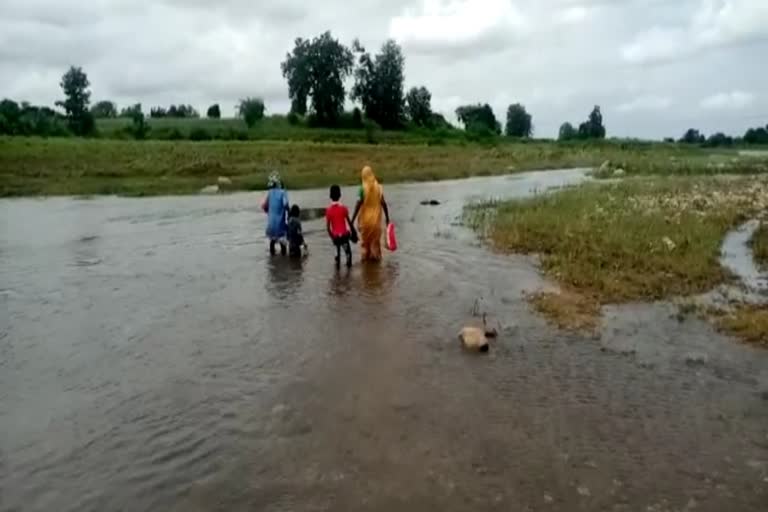 Villagers crossing the river