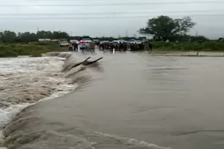 overflowing water on bridge at sattenapalli