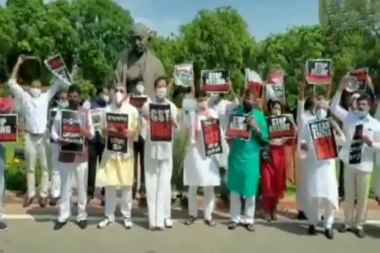 TRS, TMC, DMK, RJD, AAP, NCP, Samajwadi Party and Shiv Sena MPs protest in front of Mahatma Gandhi statue