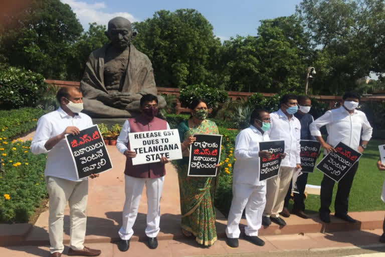 telangana-pms-protest-for-gst-arrears-in-gandhi-statue-at-parliament