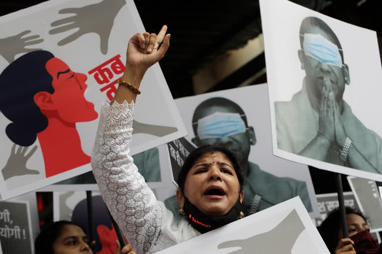 Shiv Sena party youth wing activists hold posters of Uttar Pradesh state Chief Minister Yogi Adityanath