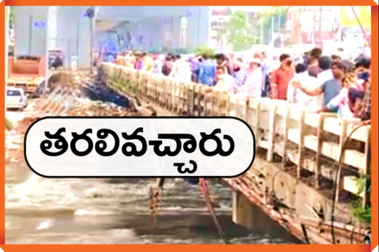 many people gathered to see water flow to musi river at attapur bridge