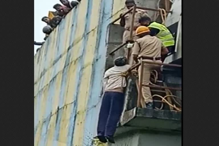 A man commits suicide by hanging himself on a railway overpass