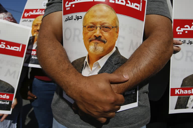 People hold posters of slain Saudi journalist Jamal Khashoggi, near the Saudi Arabia consulate in Istanbul