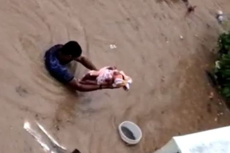 man -resques- 15 day -child- from -floods - bengalore