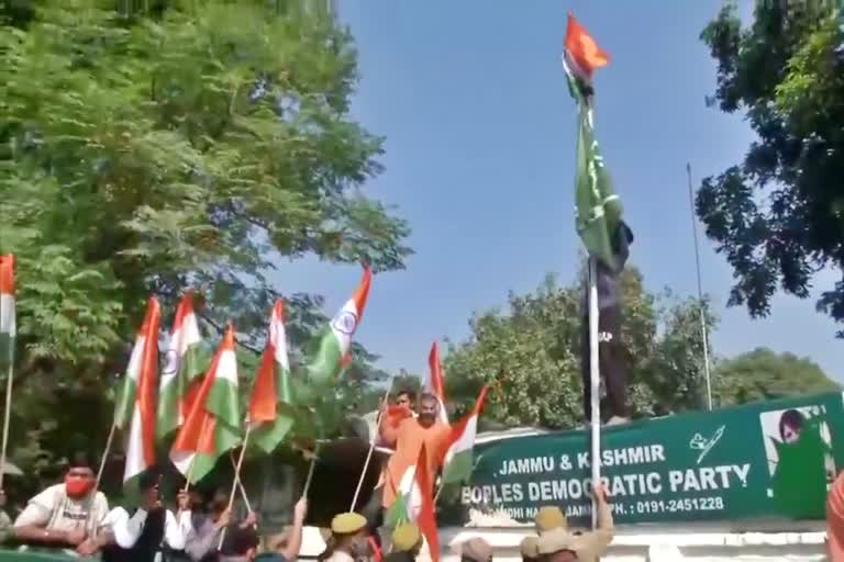 BJP workers hoist the national flag