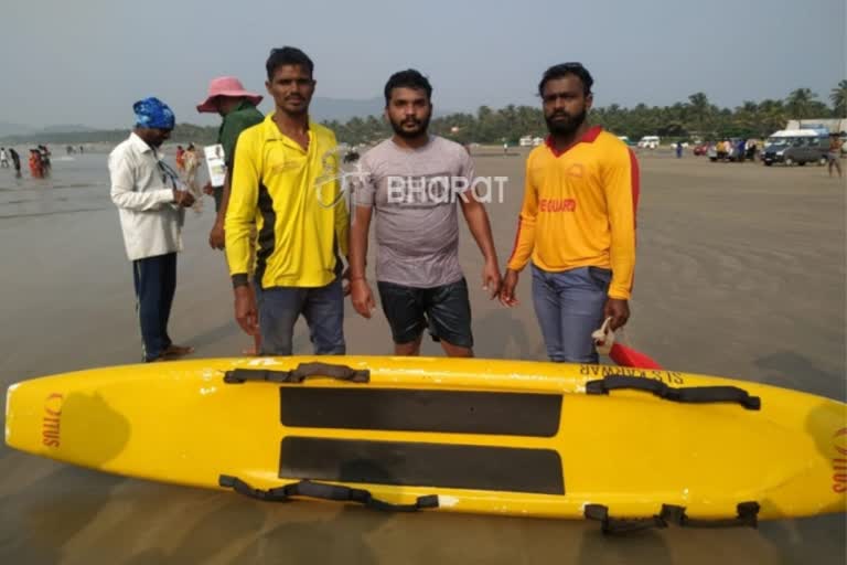 tourist protected by lifeguards in Murudeshwar Beach