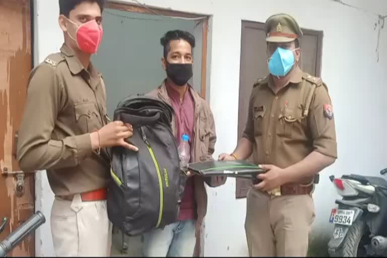 युवक बैग लौटाती पुलिस.