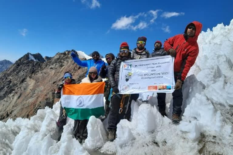 flag hoisted on friendship mountain peak