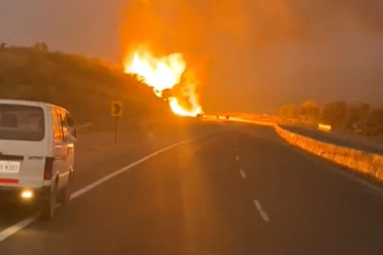 Cylinder fire as truck overturns