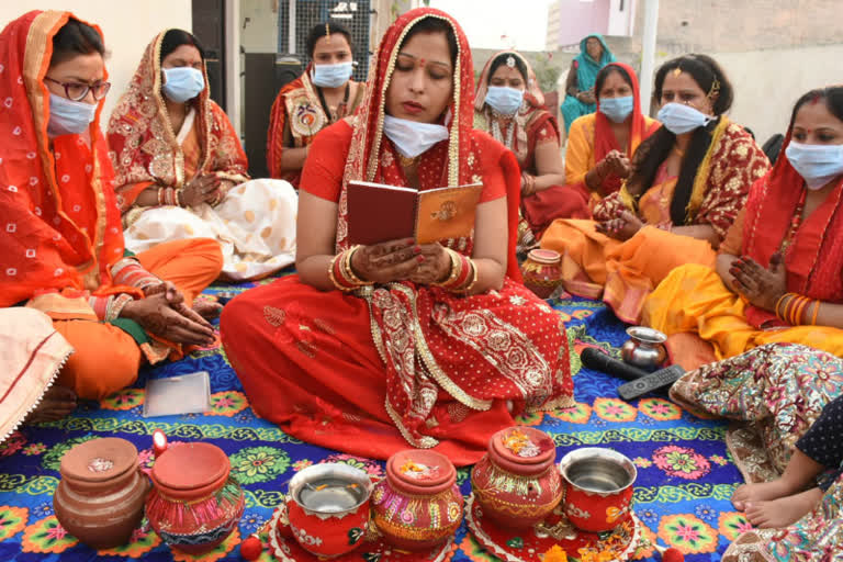 women putting masks on karva chauth