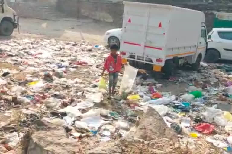 Garbage remains spread on the road of Mehrauli market near Qutub Minar in Delhi