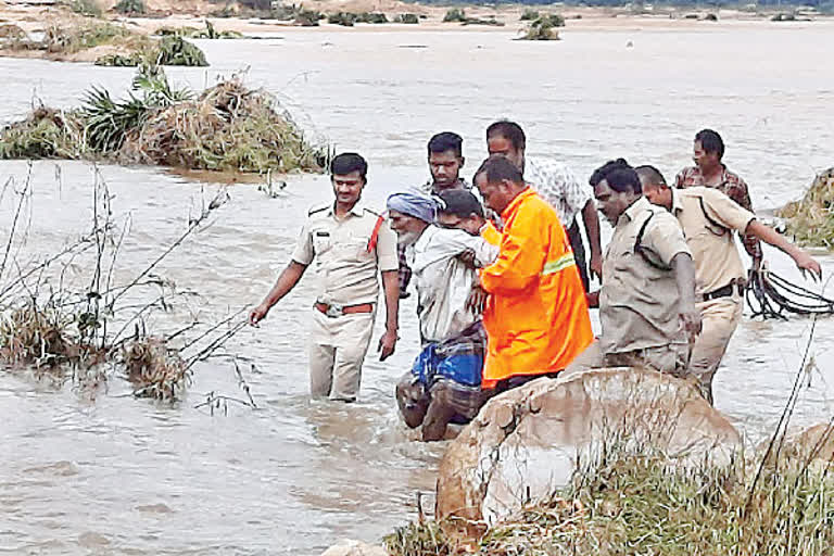 Police rescue a farmer trapped in a flood while crossing a river to go to a farm.