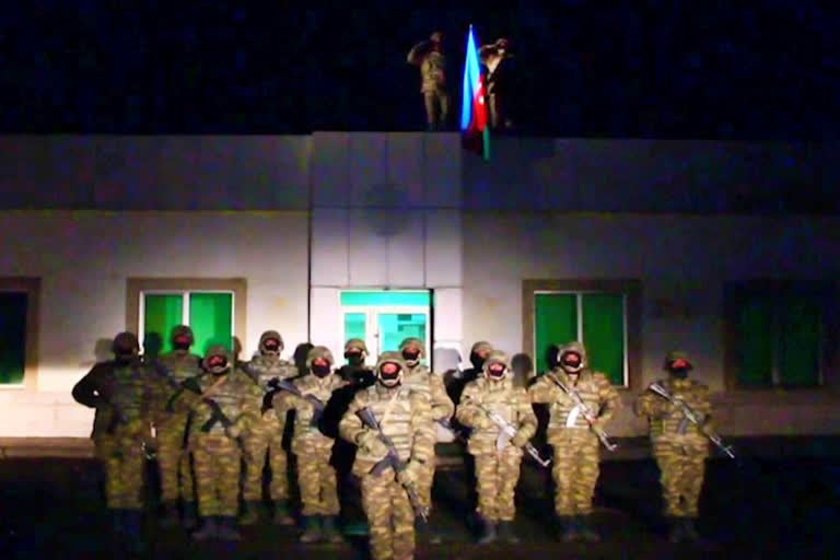Azerbaijani soldiers raise nation's flag in Lachin