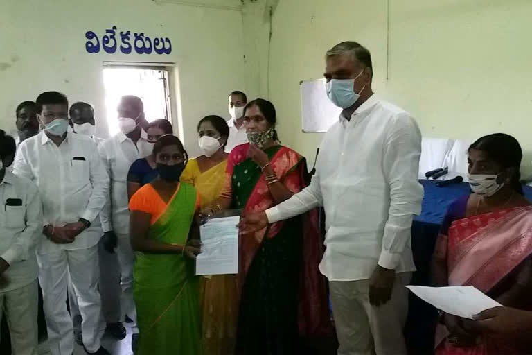 minister harish rao distribute cheques to beneficiaries in medak