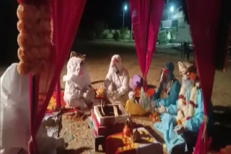 A couple gets married at Kelwara Covid Centre in Bara, Shahbad wearing PPE kits