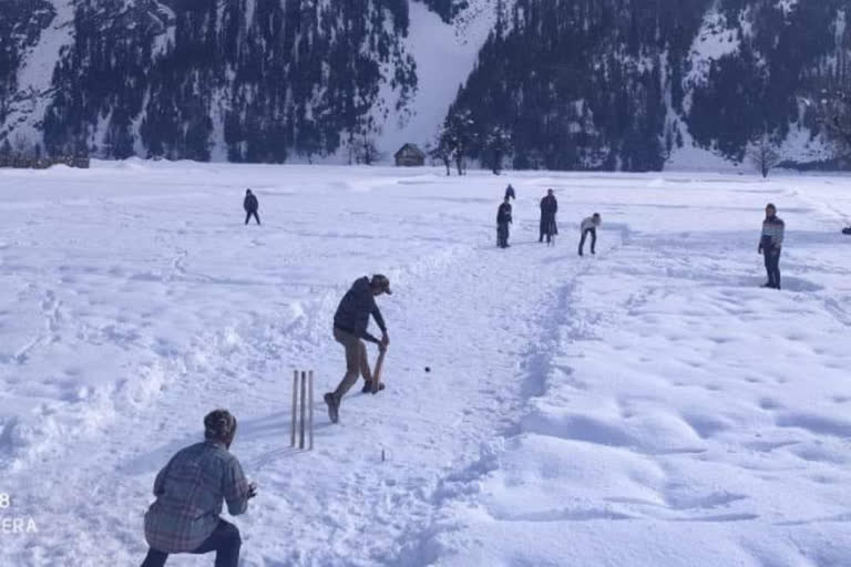 youth play cricket in snow-covered Gurez valley