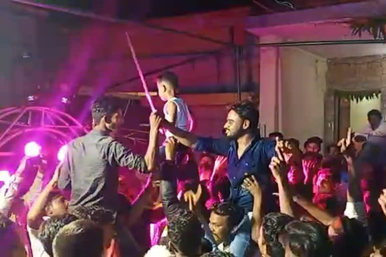 a young man Dancing with swords in marriage event in jalgoun