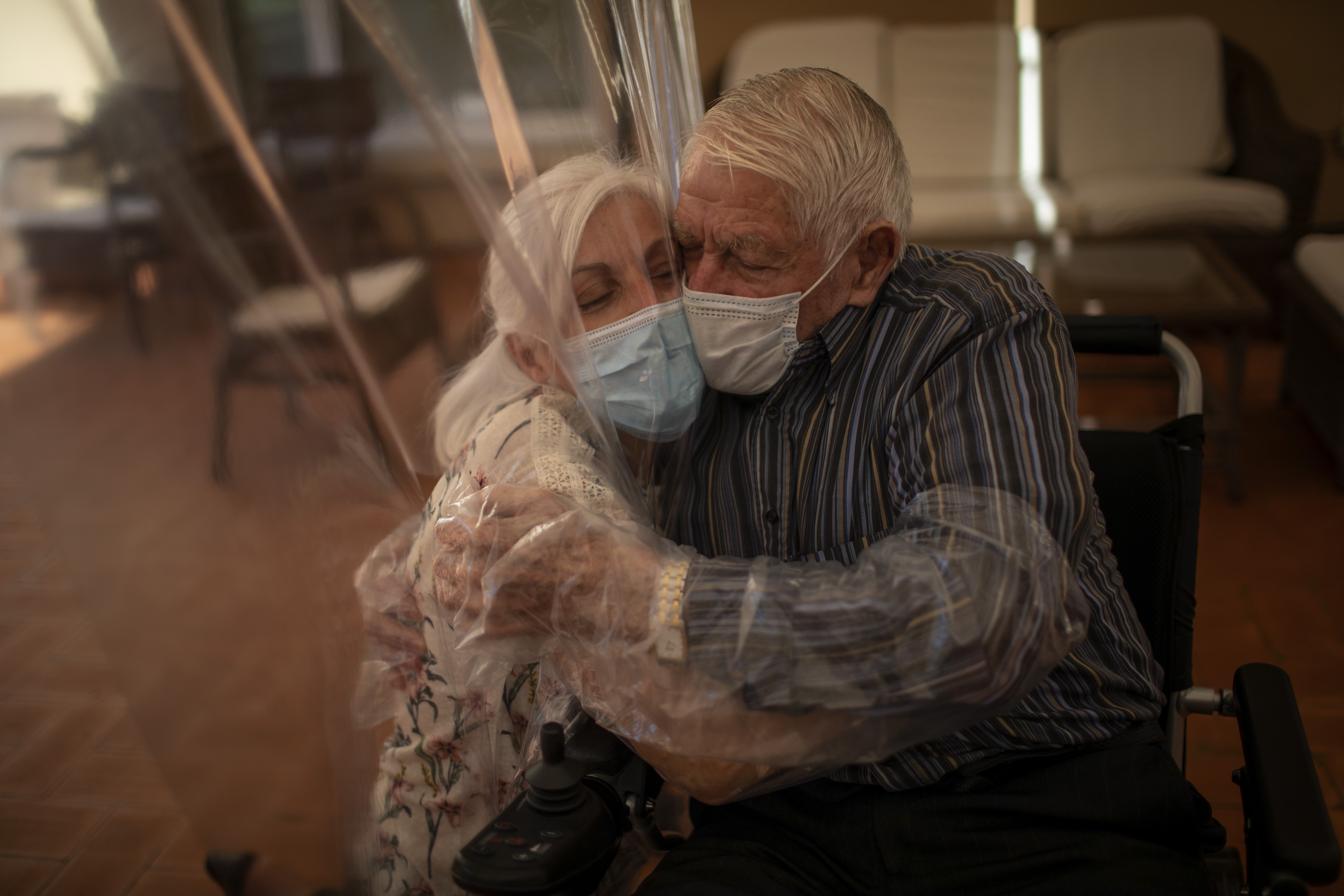 Dolores Reyes Fernández hugs her father José Reyes Lozano for the first time in nearly four months as visits resume to a nursing home in Barcelona, Spain.