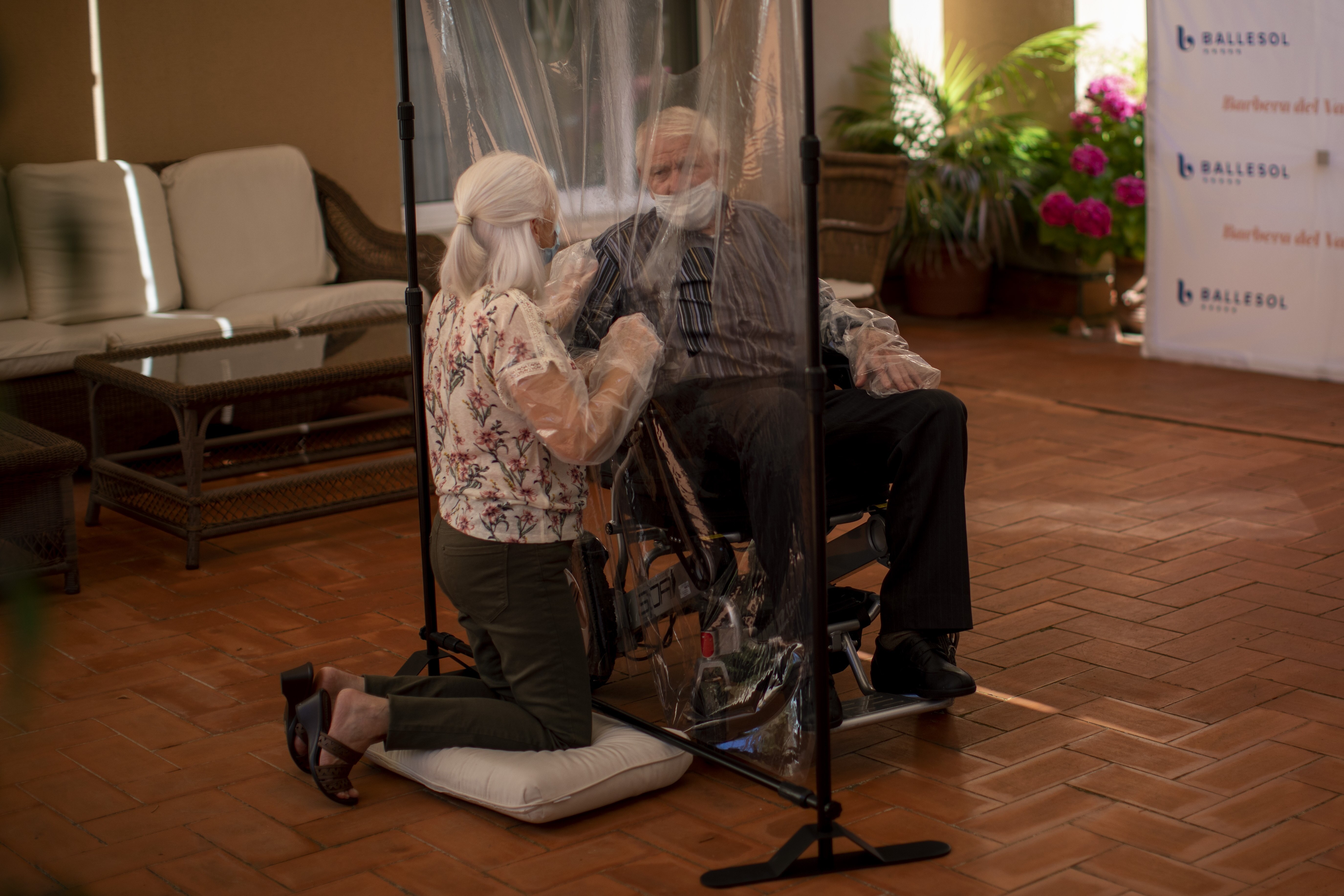 Dolores Reyes Fernández speaks with her father José Reyes Lozano for the first time in nearly four months as visits resume to a nursing home in Barcelona, Spain.